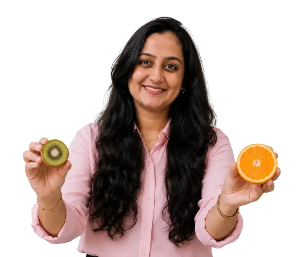 Nutritionist Dt. Foram Modi with Kiwi & Orange in hands.