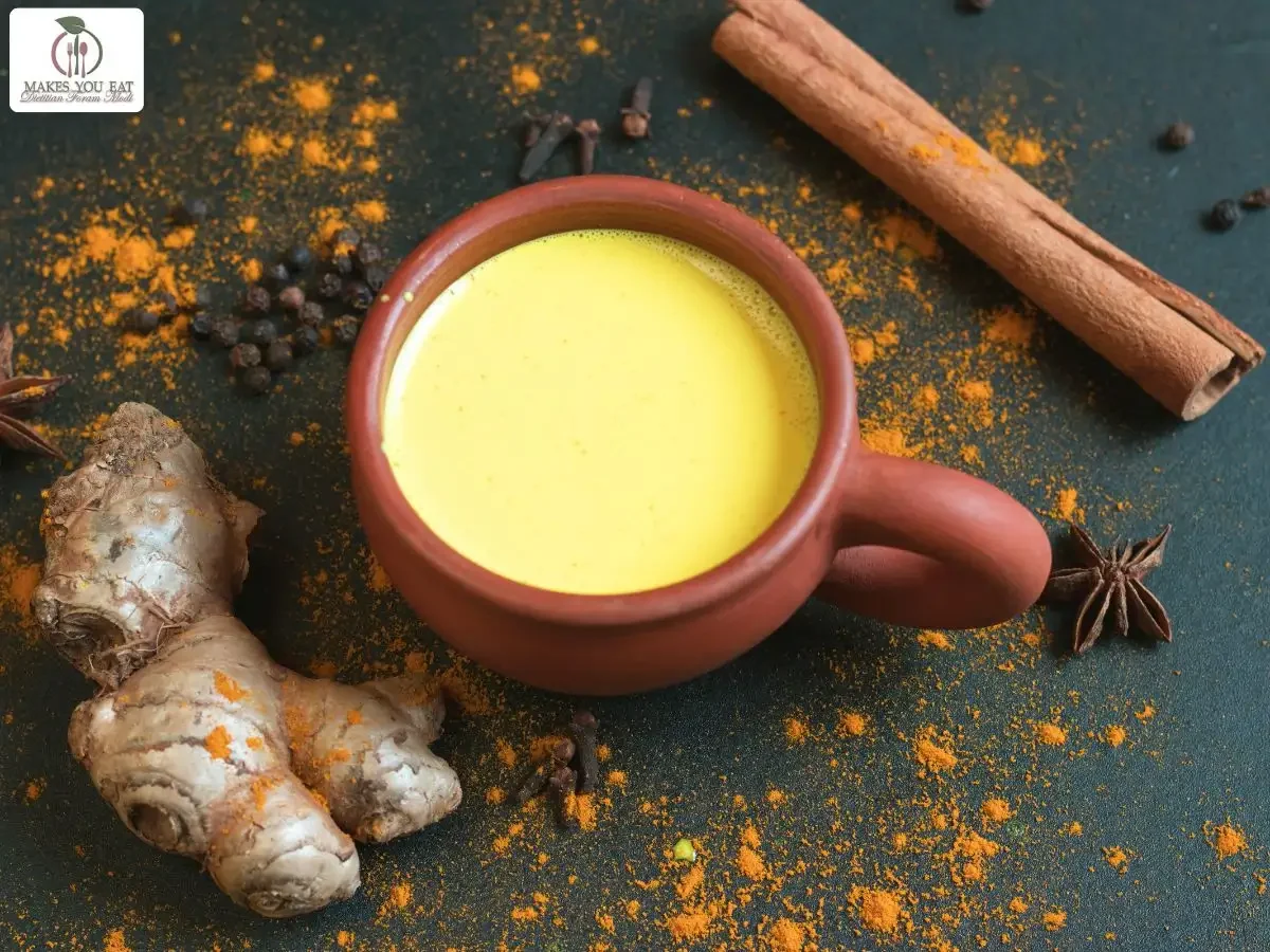 Turmeric milk with ginger on the table.