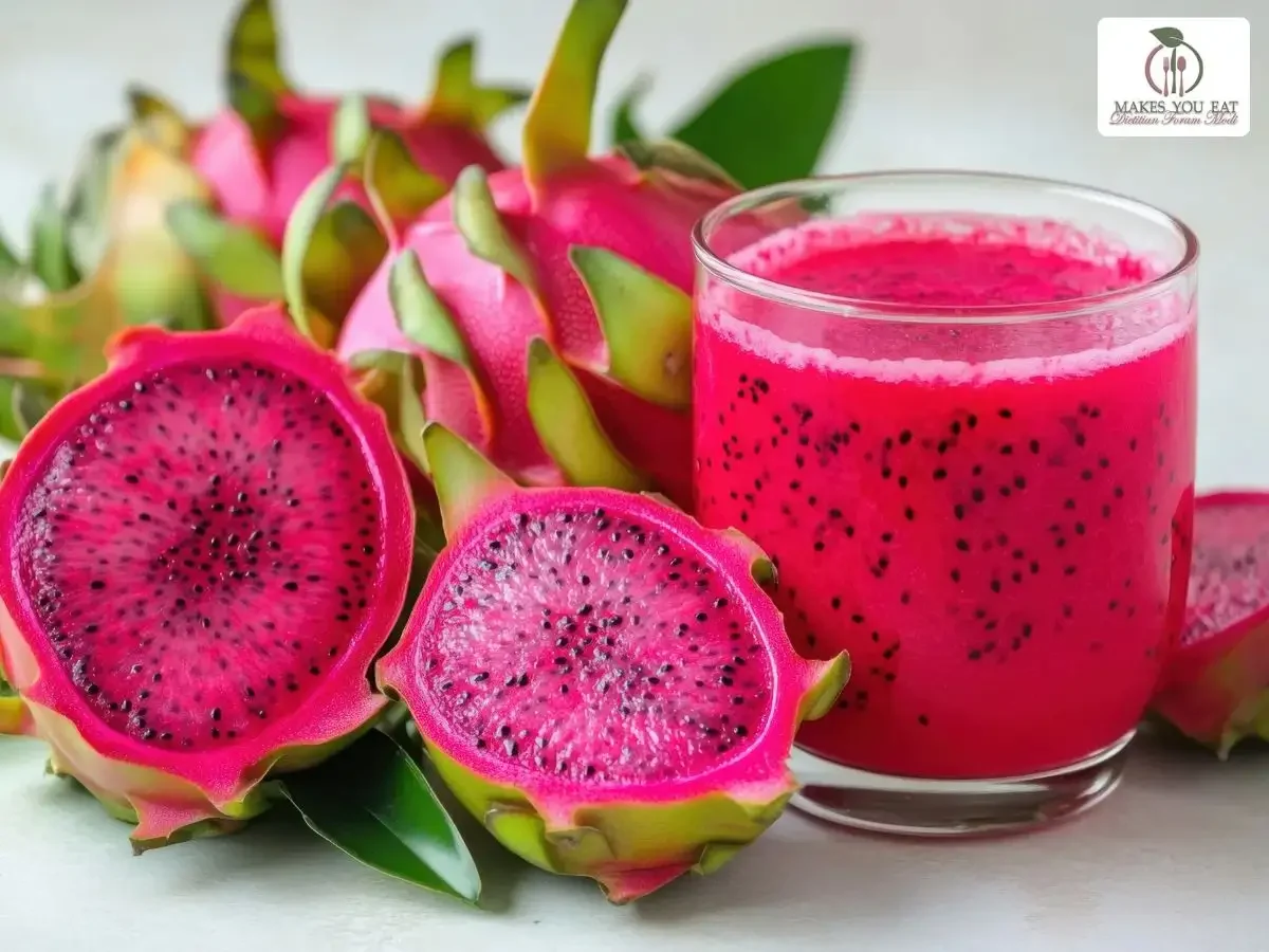Dragon fruits cut in pieces with glass full of juice.