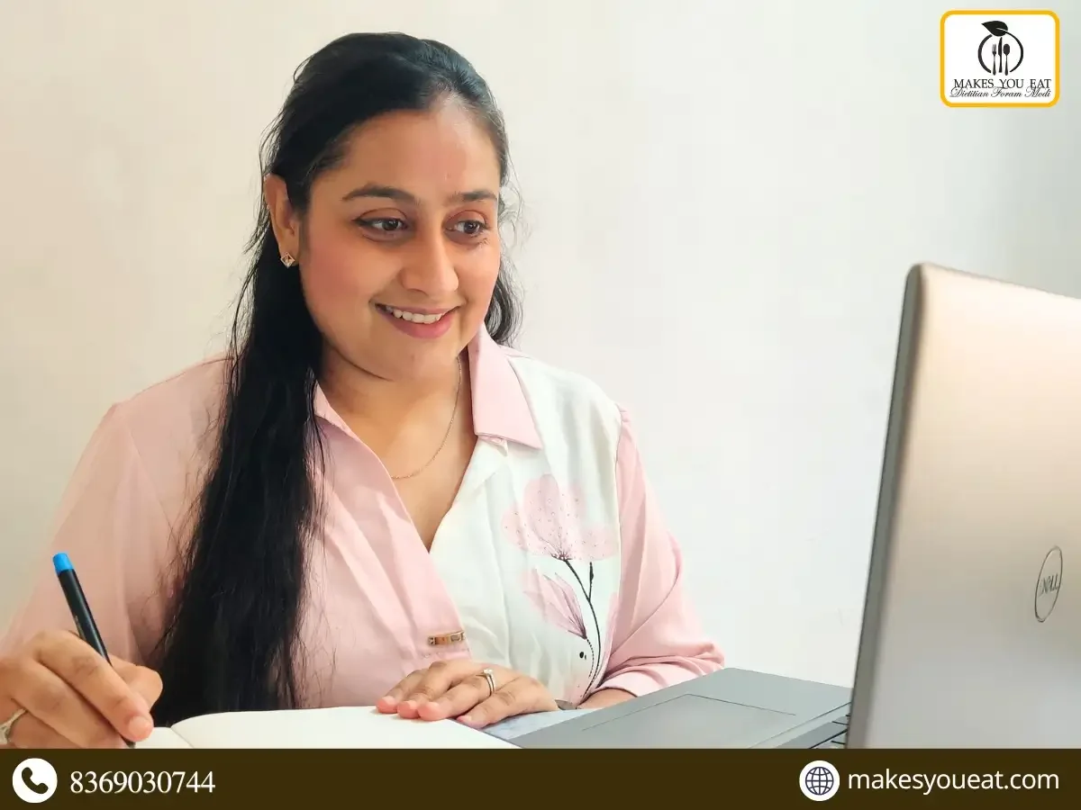 Dt. Foram Modi sitting in front of laptop.