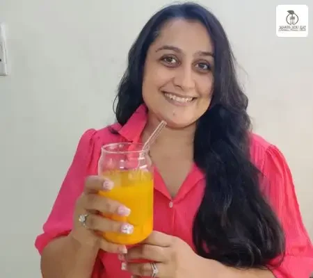 Gut Health Dietitian Foram Modi Holding Juice Glass.