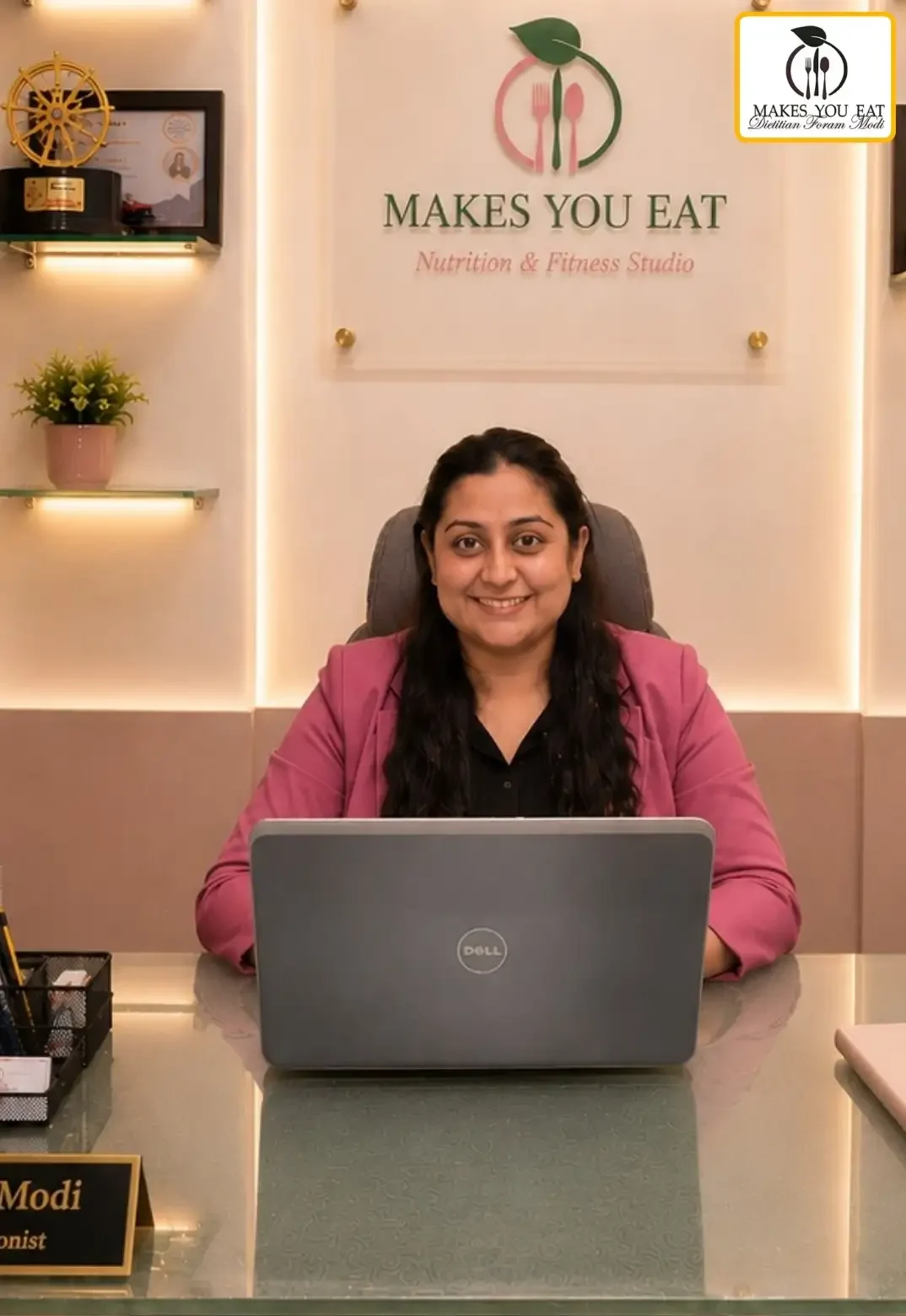 Pediatric Nutritionist Dt. Foram Modi working on laptop.