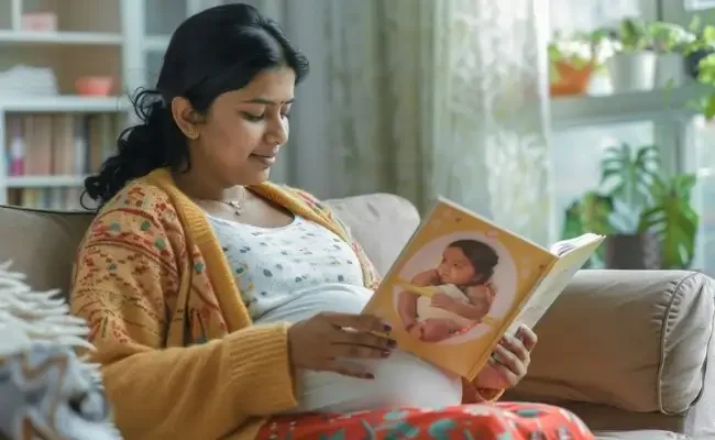 Indian pregnant women reading babies book.