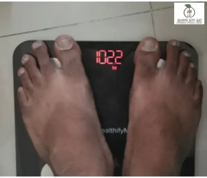 A weighting scale showing showing Ritesh intermittent weight - 102.2 during weight loss diet plan