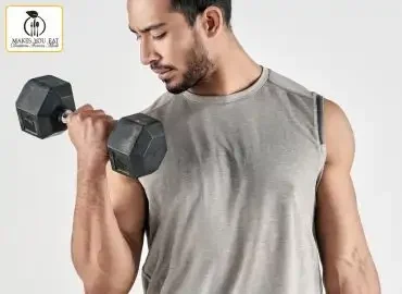 Young adult holding dumbbells.